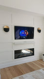 Custom built media wall with a recessed niche for the flat screen TV,  an electric fireplace  and board and batten wall treatment gives this space a cozy sleek & modern look. 